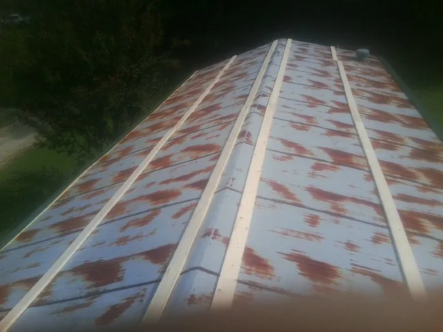 Rusted metal roof panels with new wood purlins before replacement — Storm Damage Roof Repair in Cub Run by Roofing Brothers