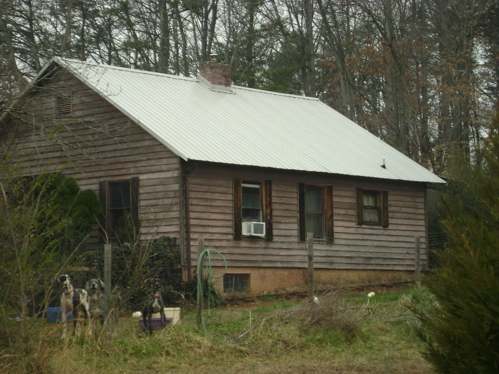 White metal roof on an old wood sided farmhouse, from a Metal Roof Installation job in Cub Run